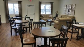 Wooden table with chairs in a room